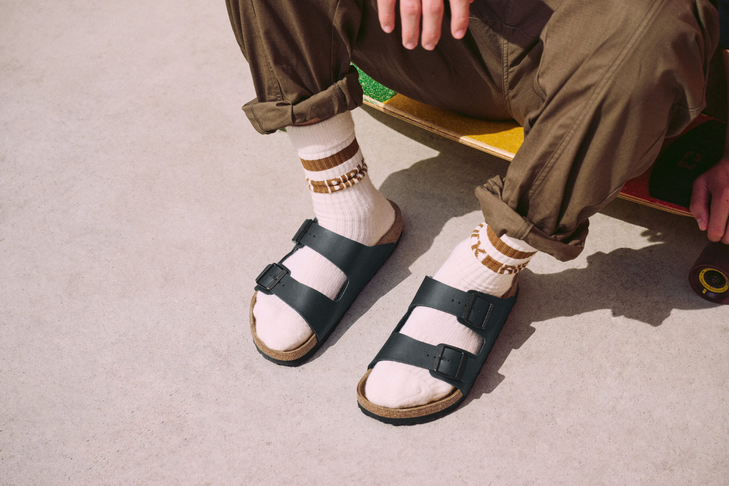 zwei Füße, die dunkelblaue Sandalen tragen